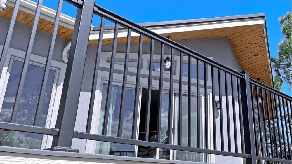 Black aluminum railings vs traditional wrought iron on a Victoria BC oceanfront deck.